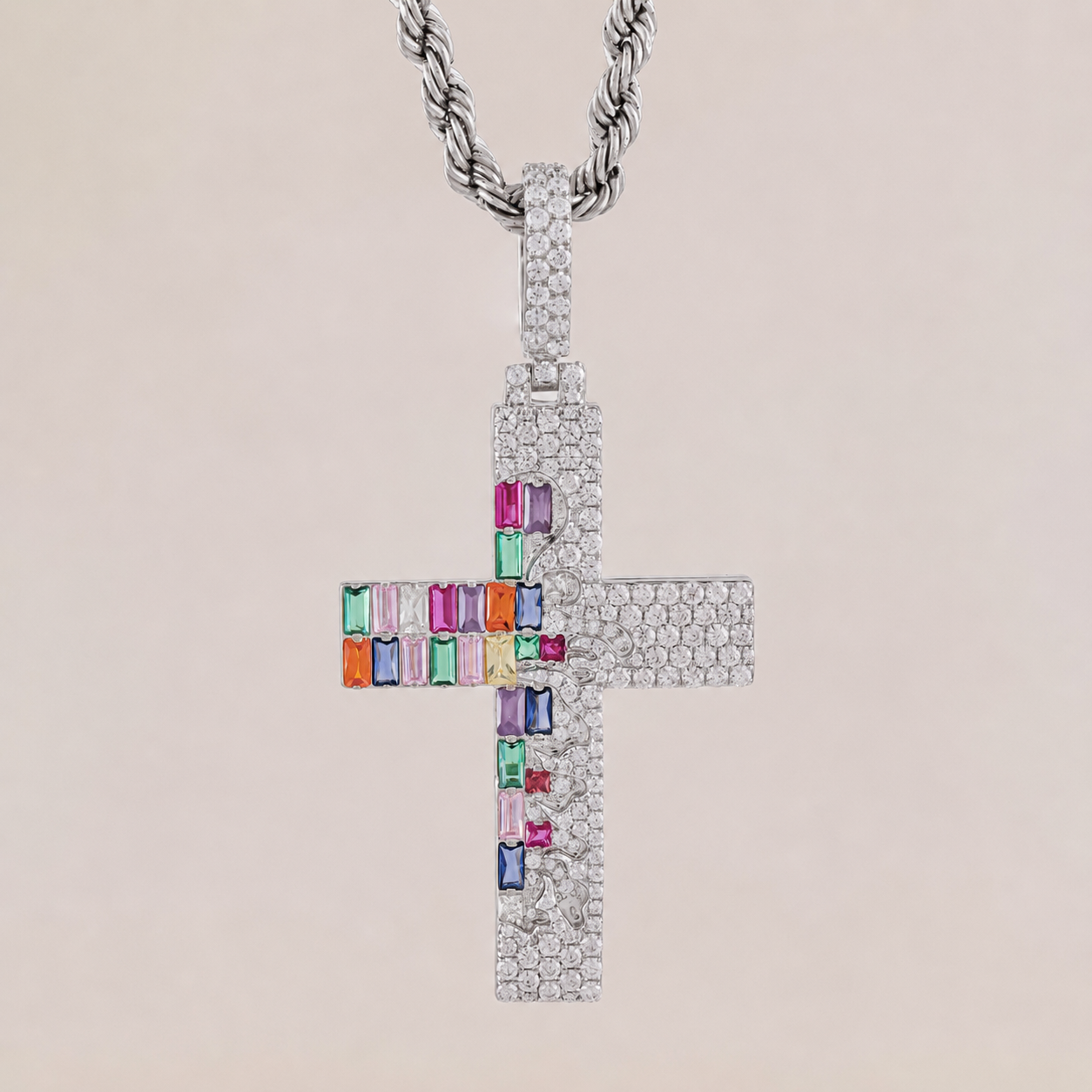 Cross-shaped pendant with colorful gemstones on a beige background