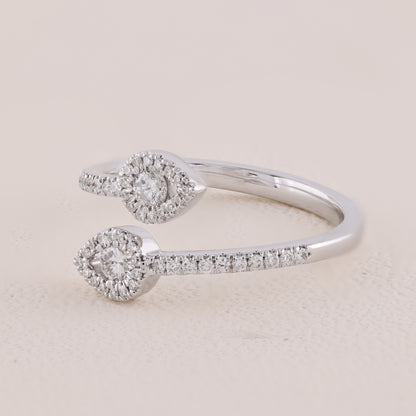 Silver ring with diamond accents on a light beige background