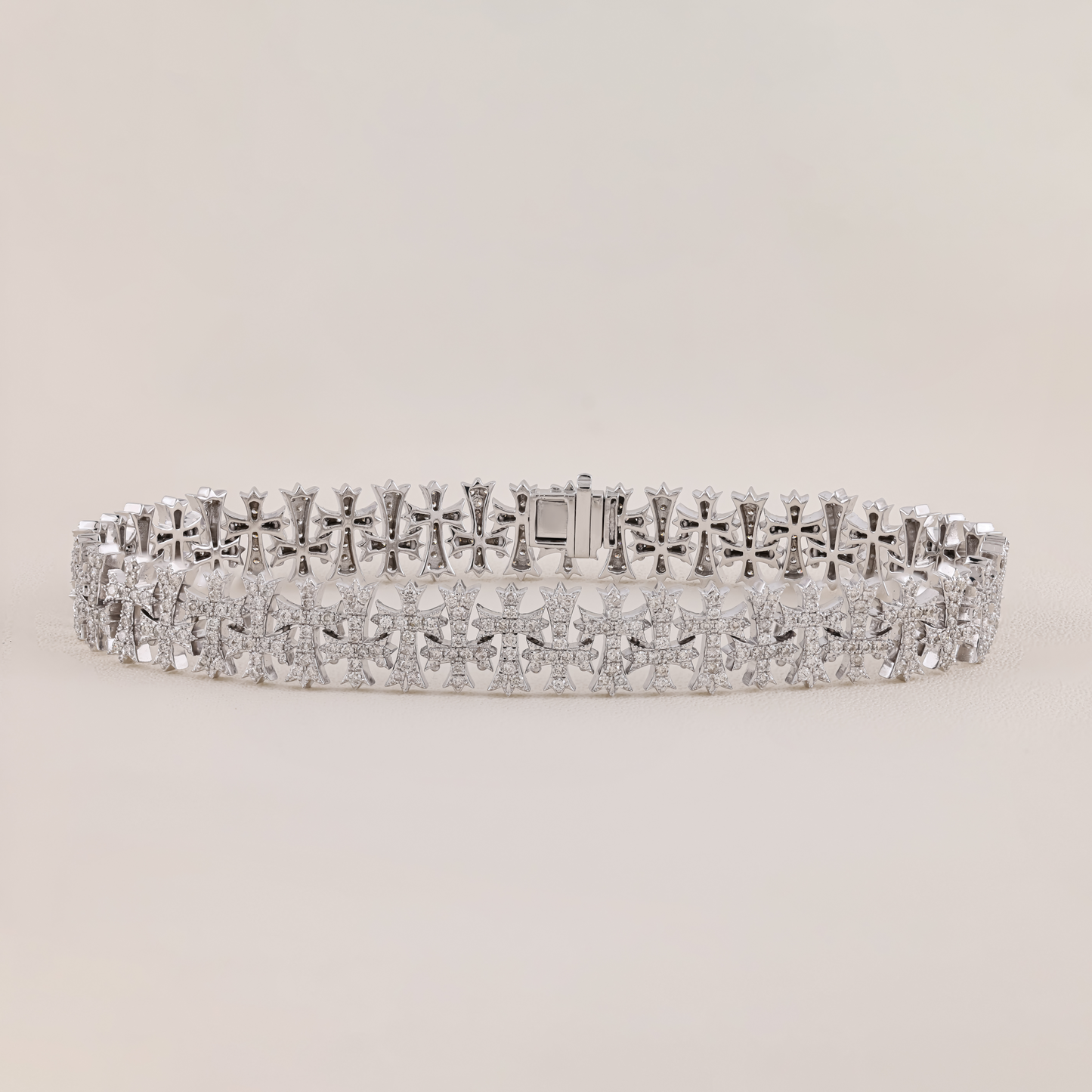 Silver bracelet with diamond accents on a light gray background