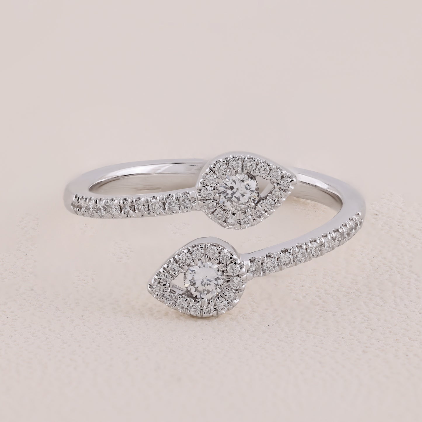Silver ring with diamond accents on a beige background