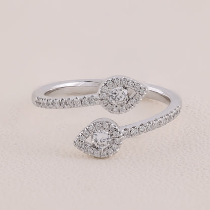 Silver ring with diamond accents on a beige background