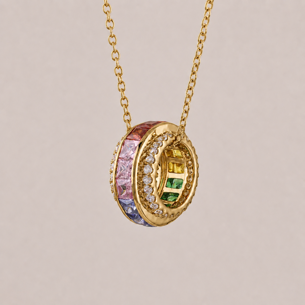 Gold necklace with a colorful pendant on a beige background