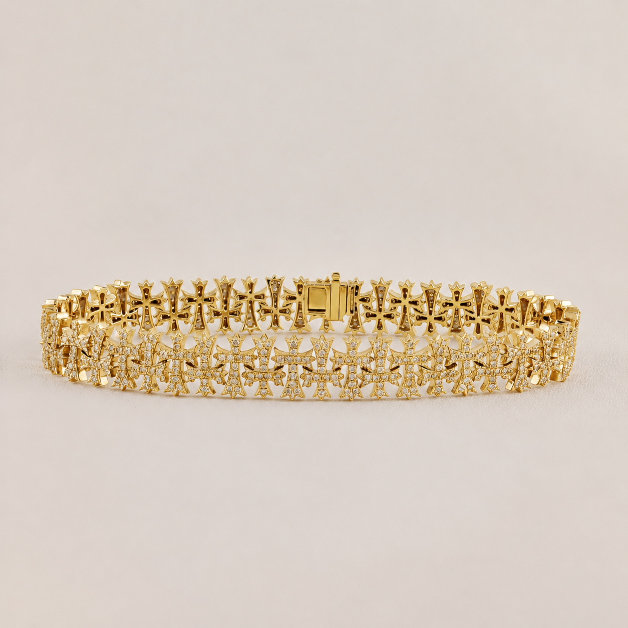 Gold bracelet with intricate design on a light beige background