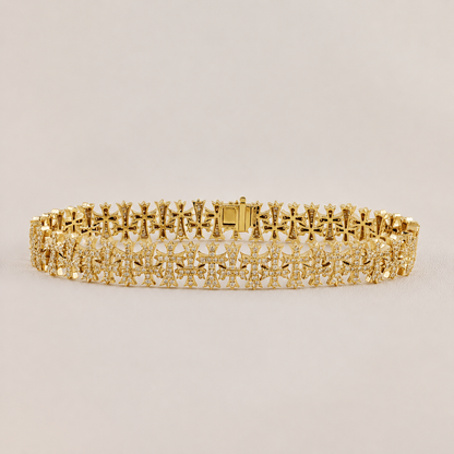 Gold bracelet with intricate design on a light beige background