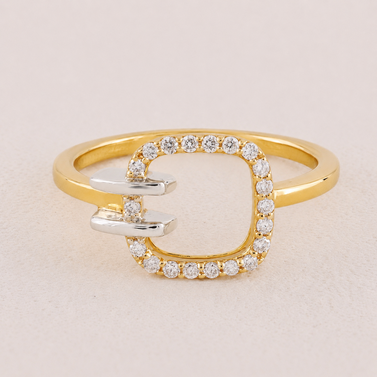Gold ring with diamond accents on a beige background