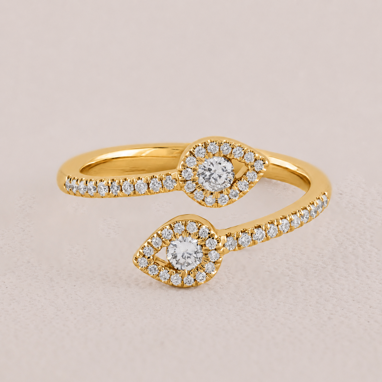 Gold ring with diamond accents on a beige background