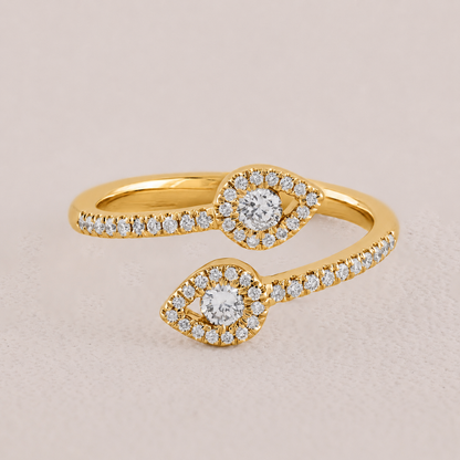 Gold ring with diamond accents on a beige background