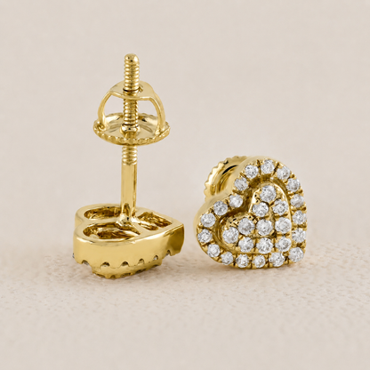 Gold earring with diamond accents on a beige background