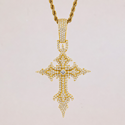 Gold cross pendant necklace with diamonds on a light gray background