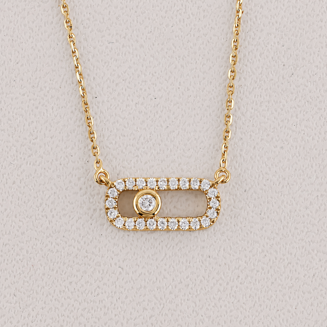 Gold necklace with a pendant on a light gray background