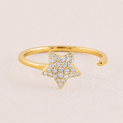 Gold bracelet with a star-shaped diamond design on a beige background