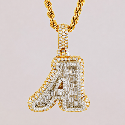 Gold necklace with a diamond-encrusted letter 'A' pendant on a light pink background