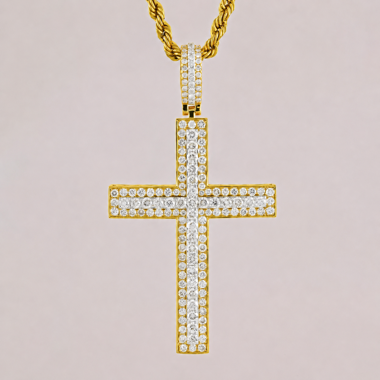 Gold cross pendant with diamonds on a light pink background