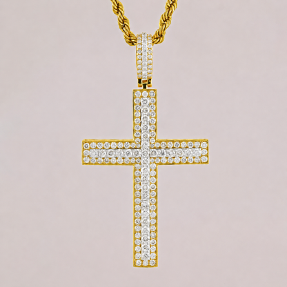 Gold cross pendant with diamonds on a light pink background