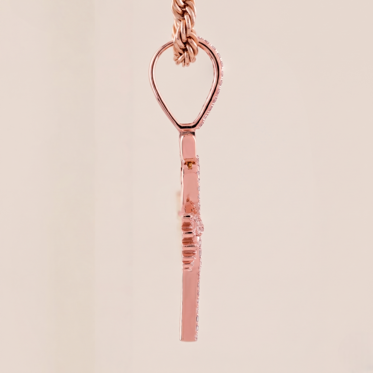 Rose gold necklace with a unique pendant on a beige background