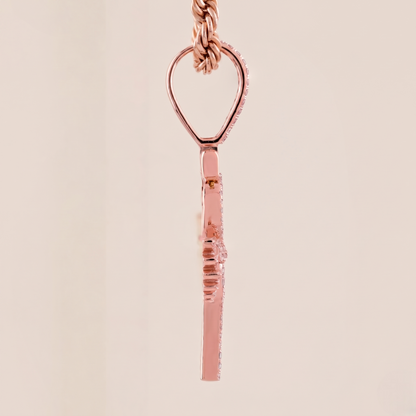 Rose gold necklace with a unique pendant on a beige background