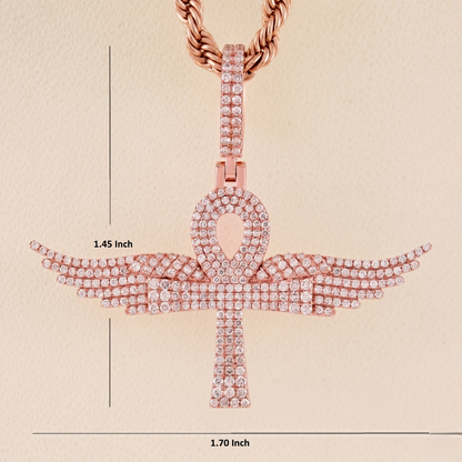 Rose gold ankh pendant with measurements on a beige background