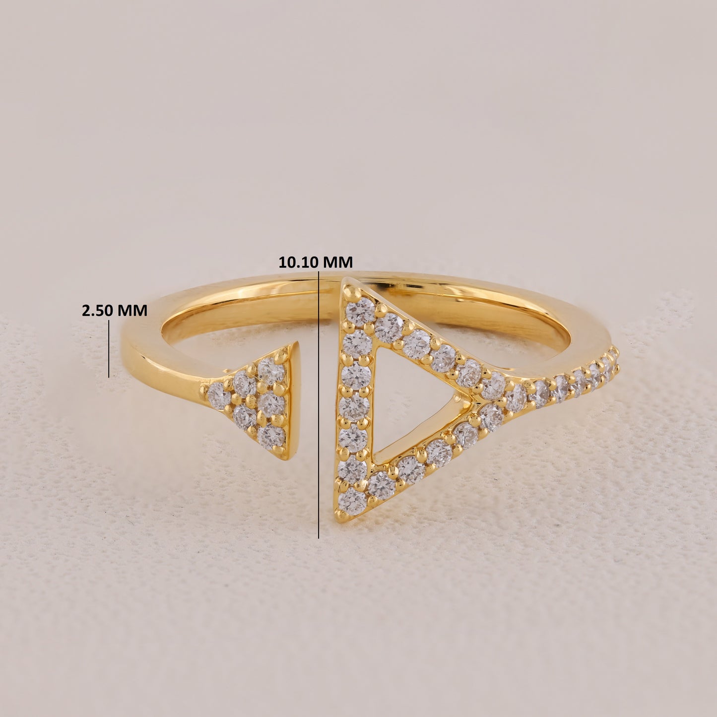 Gold ring with diamond accents and size measurement labels on a light background