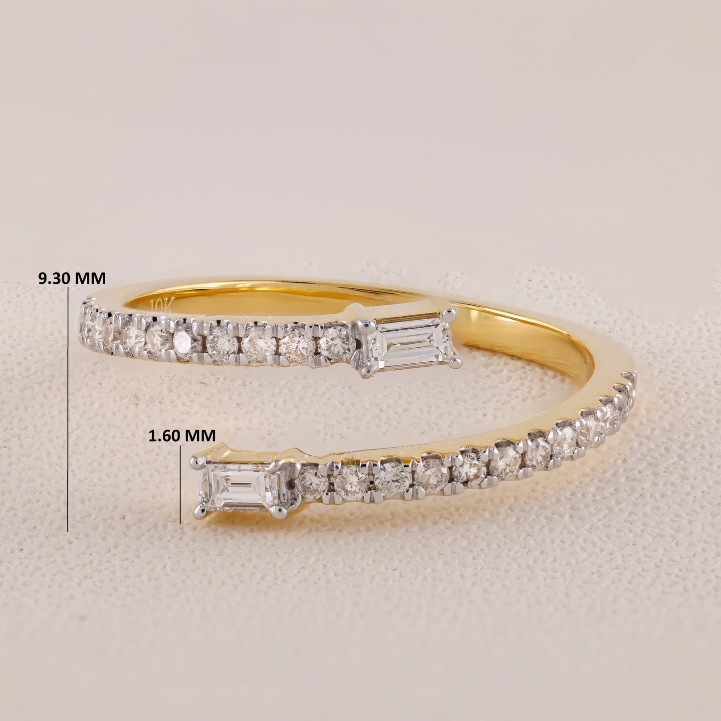 Gold bracelet with diamond accents and measurements on a light gray background