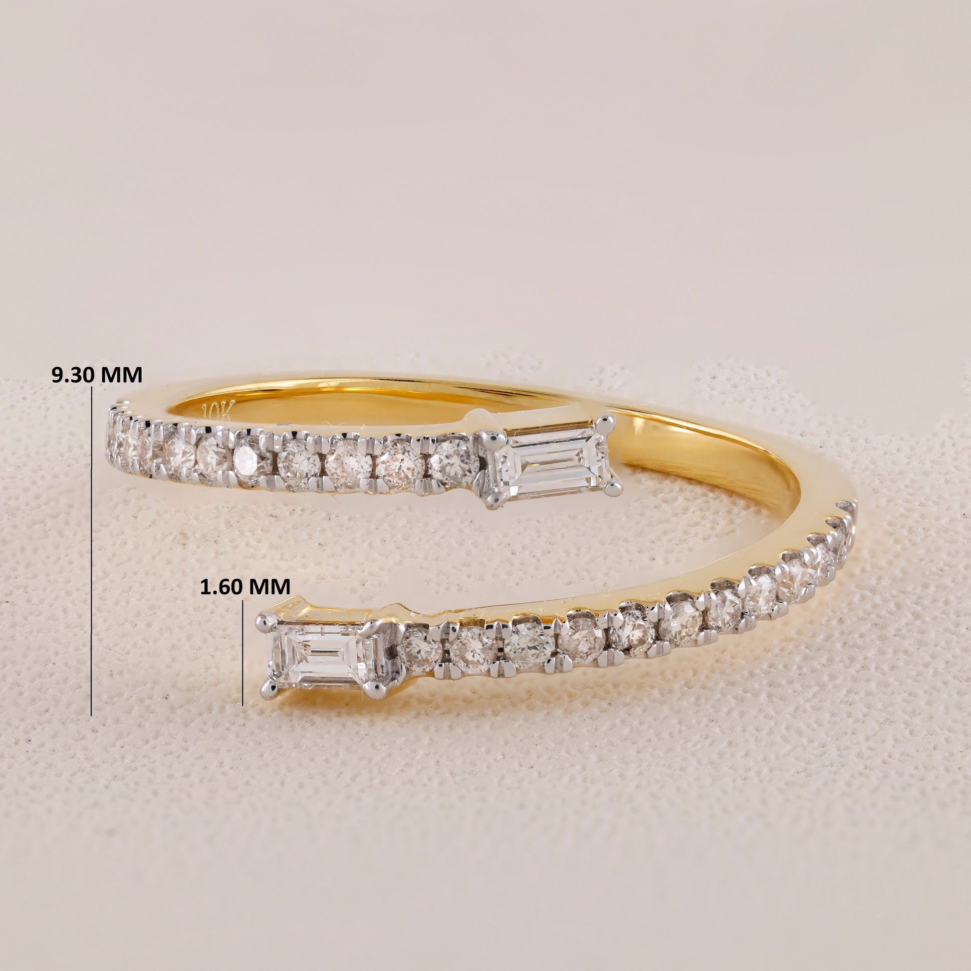 Gold bracelet with diamond accents and measurements on a light gray background