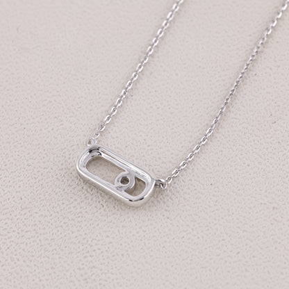 Silver necklace with a unique pendant on a light gray background