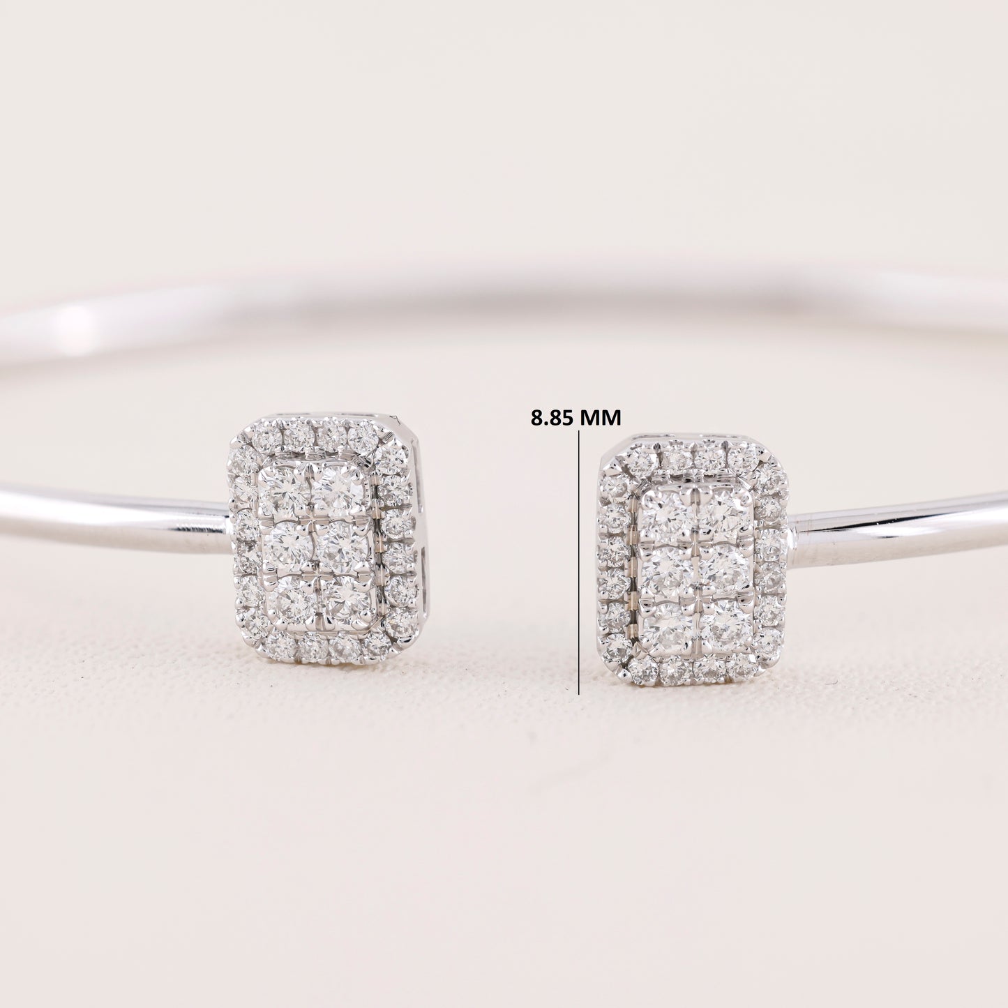 Diamond earrings on a light gray background with measurement label.