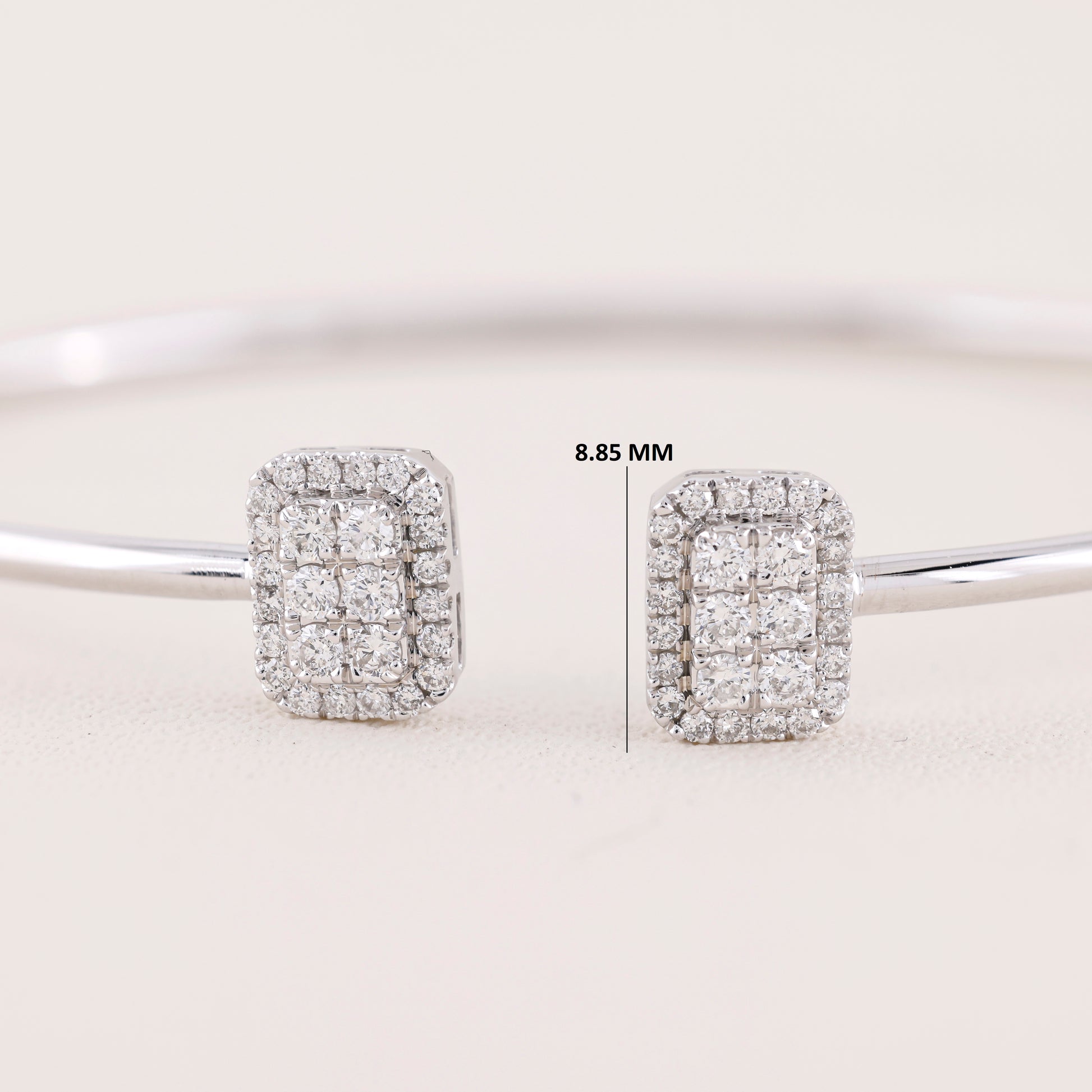 Diamond earrings on a light gray background with measurement label.