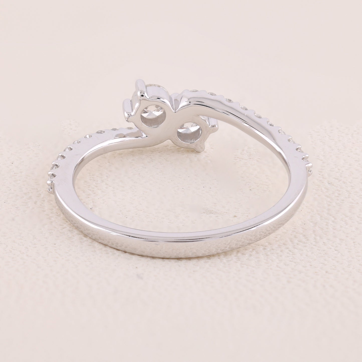 Silver ring with a unique design on a light beige background