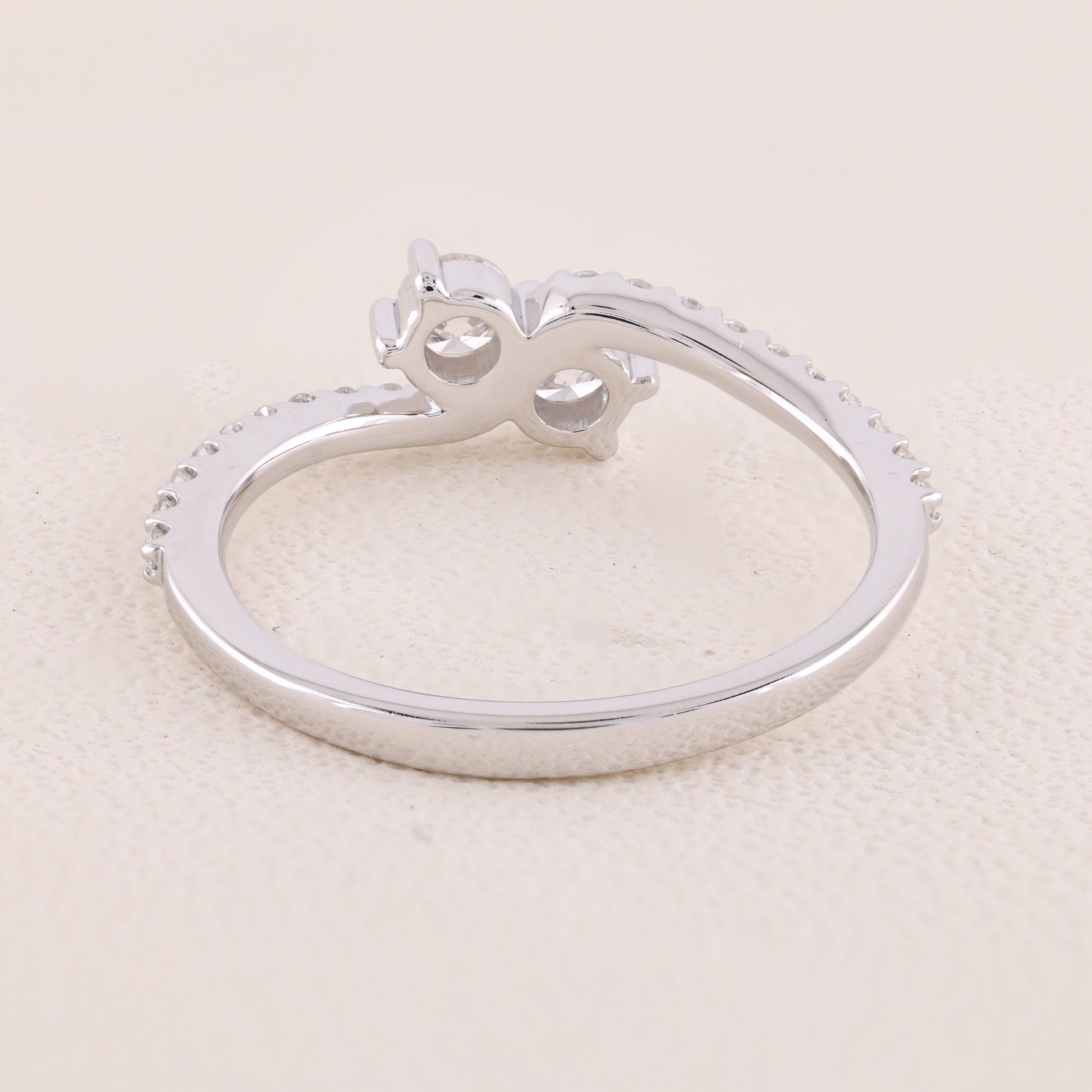 Silver ring with a unique design on a light beige background