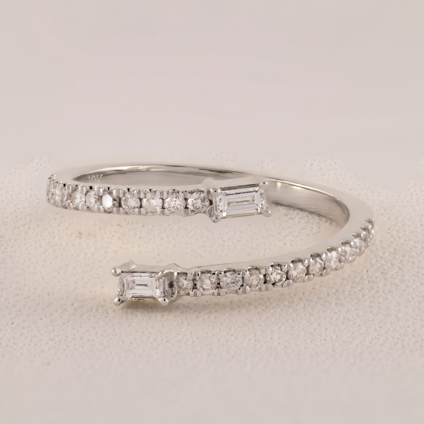 Silver bracelet with diamond accents on a light gray background