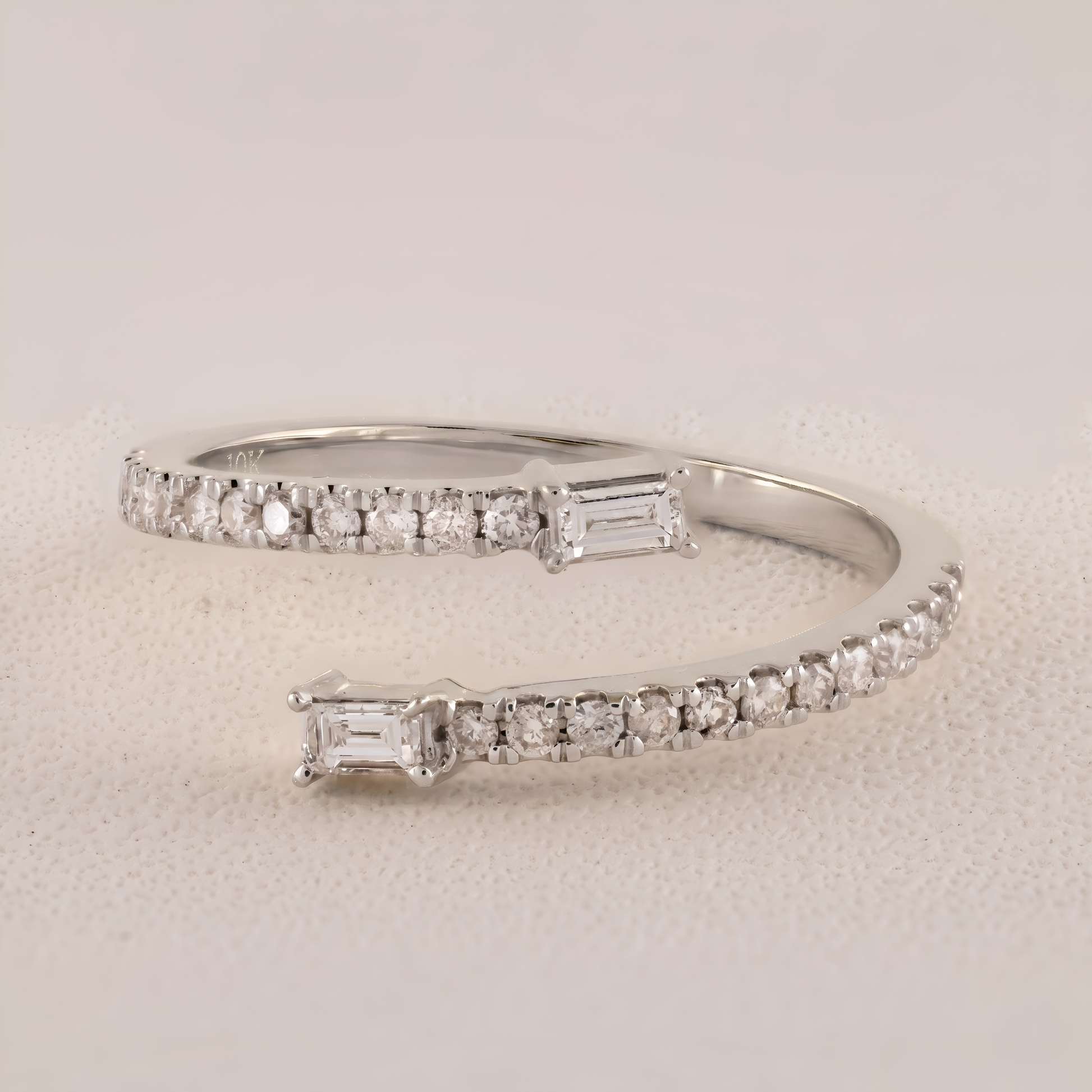 Silver bracelet with diamond accents on a light gray background