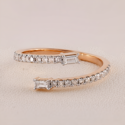 Rose gold ring with diamond accents on a beige background