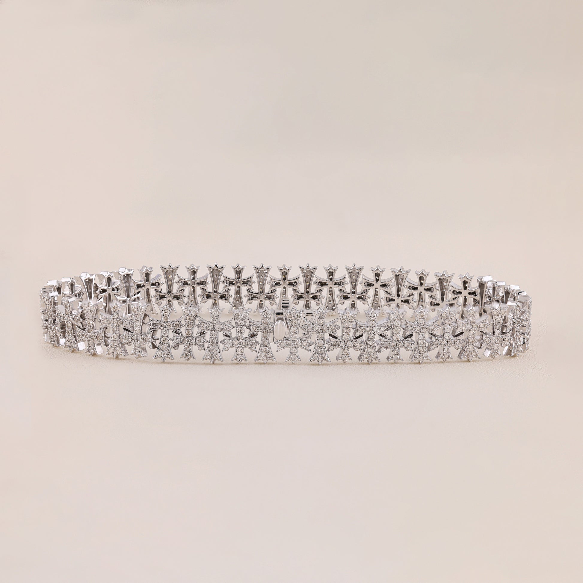 Silver bracelet with diamond accents on a beige background