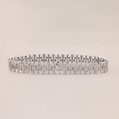Silver bracelet with diamond accents on a beige background