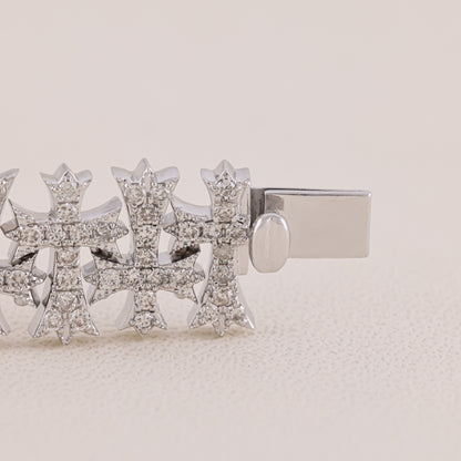 Silver earring with diamond-like stones on a beige background