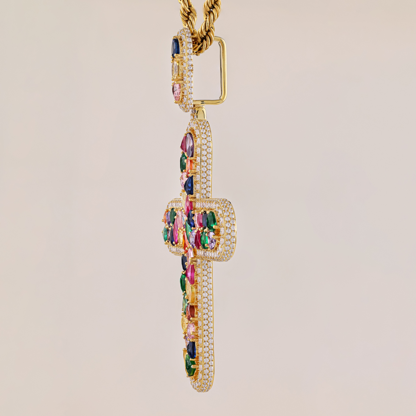 Gold necklace with colorful gemstones on a beige background