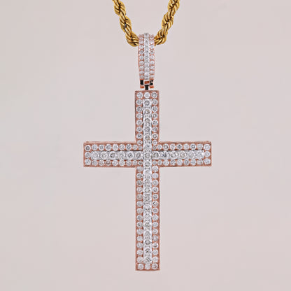 Rose gold cross pendant with diamonds on a light pink background