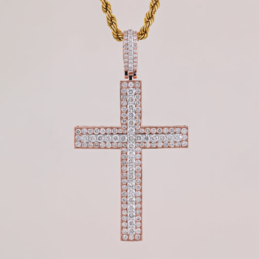 Rose gold cross pendant with diamonds on a light pink background