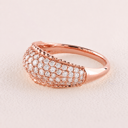 Rose gold ring with diamonds on a light pink background