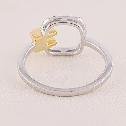 Silver ring with a gold accent on a light beige background