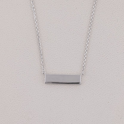 Silver bar necklace on a light gray background