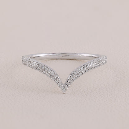 Silver ring with diamond accents on a beige background