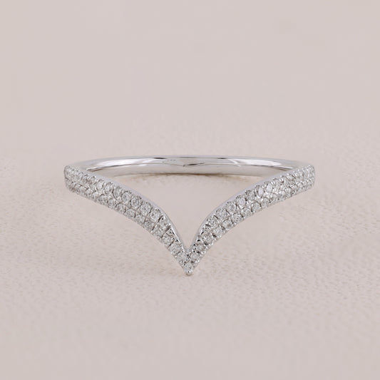Silver ring with diamond accents on a beige background