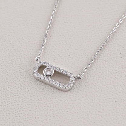 Silver necklace with a rectangular pendant on a light gray background