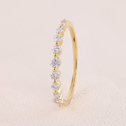 Gold ring with diamonds on a beige background