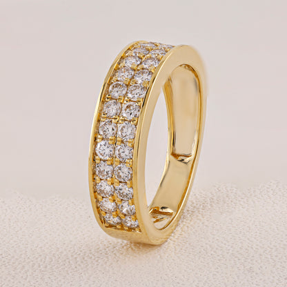 Gold ring with diamond stones on a beige background