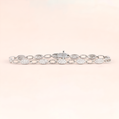 Silver bracelet with clear stones on a light pink background
