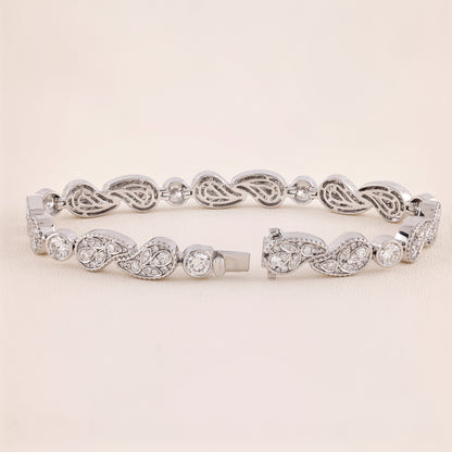 Silver bracelet with intricate design on a light beige background