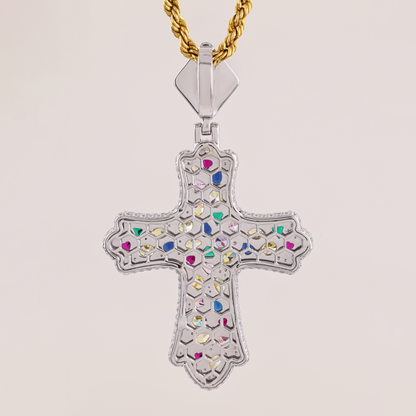 Decorative cross pendant with colorful stones on a gold chain against a light background