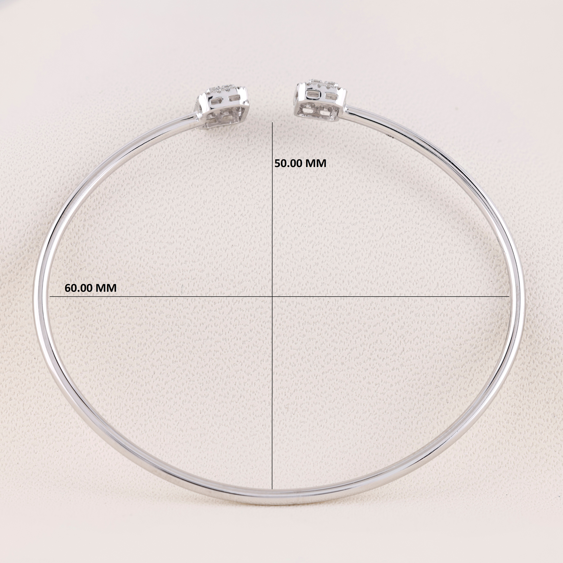 Circular metal ring with measurement markings on a beige background